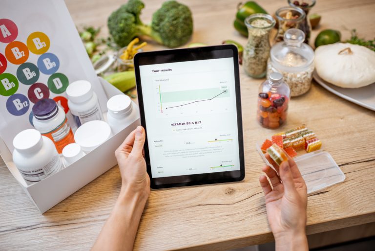 Woman checking result of medical tests on tablet with nutritional supplements