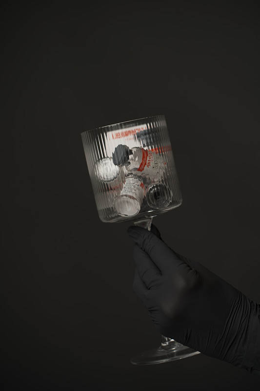 Wine glass filled with Jeuveau Vials