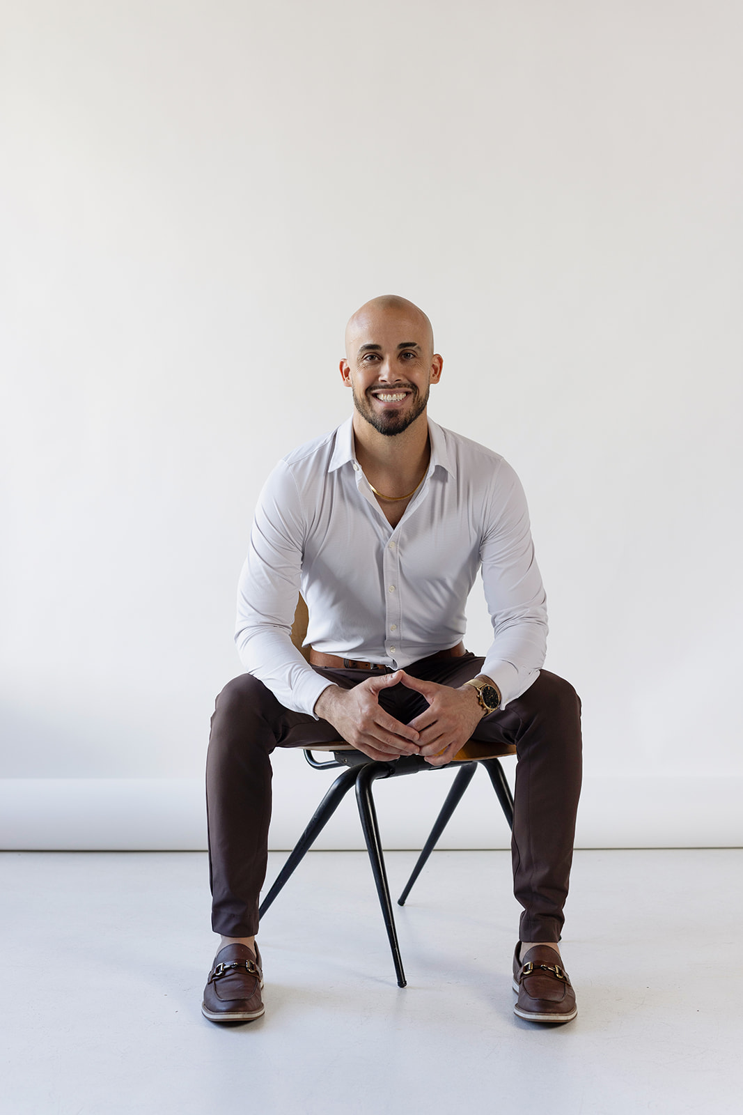 Dr Ben sitting in a chair. smiling.